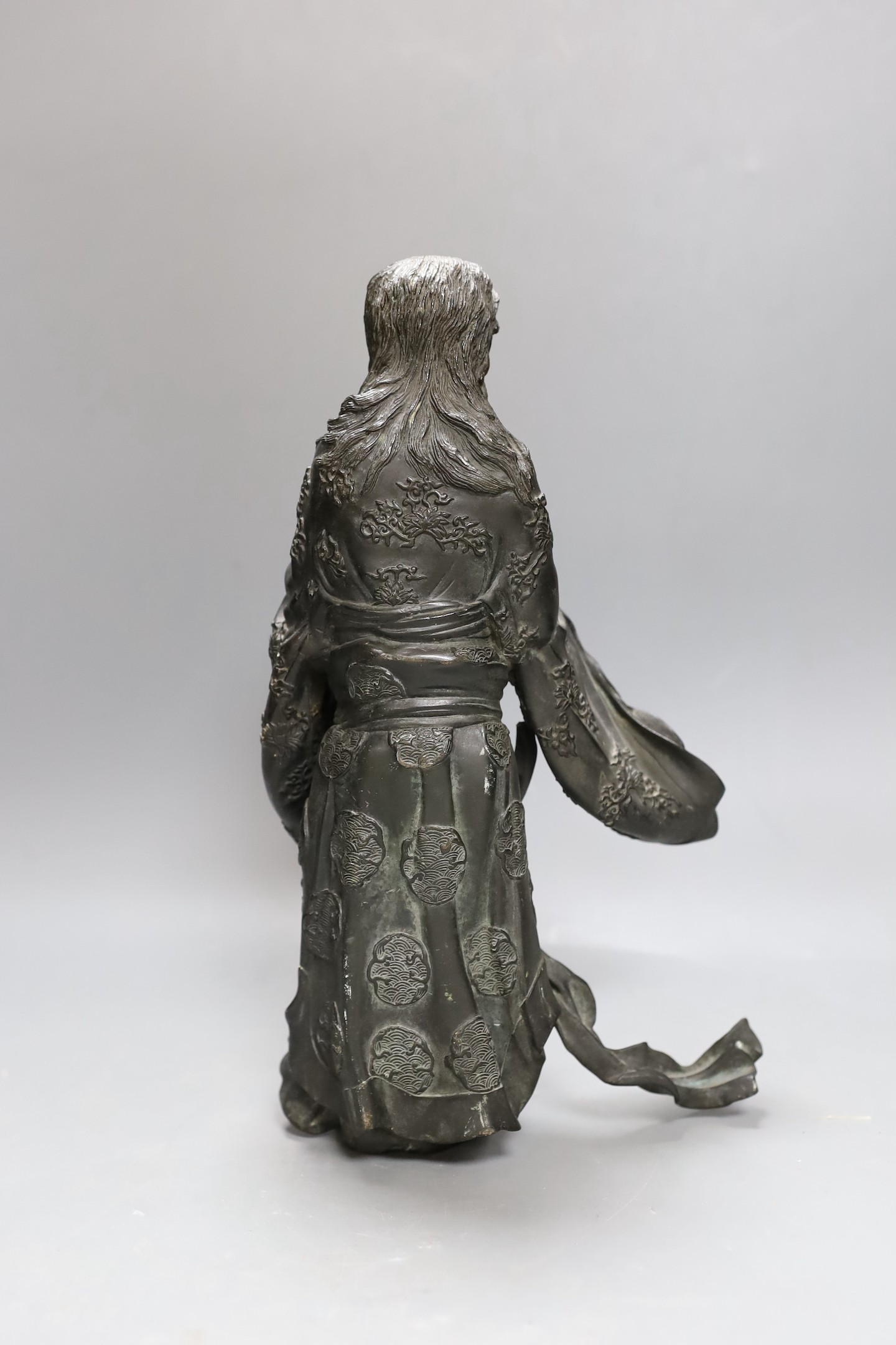 A heavily cast Japanese bronze figure of a bearded man with flowing robes, Meiji period, 31cm tall
